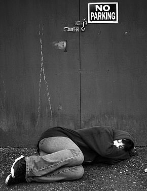 Lonely girl sleeping on ground.